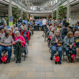 Full view of the audience at the showcase with mall in the background