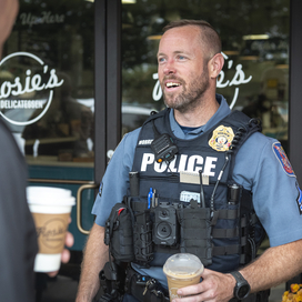 Officer talks to citizen at Coffee with a Cop