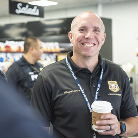 Officer smiling with a cup of coffee