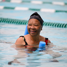 Woman participating in water aerobics activity