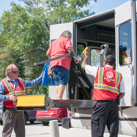 Female older adult testing out public transit lift