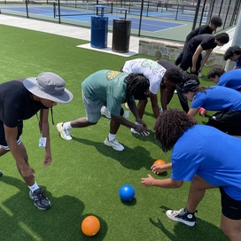 Staff and volunteers line up for a competition.